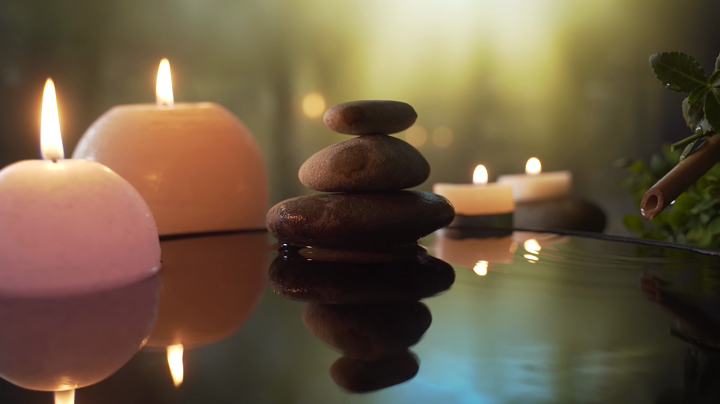 Serene spa wellness scene with stacked stones and candles